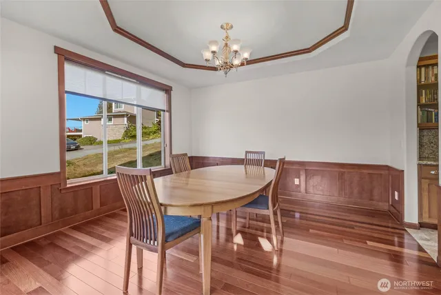 a kitchen with stainless steel appliances granite countertop a refrigerator a sink dishwasher a stove with wooden floors and cabinets