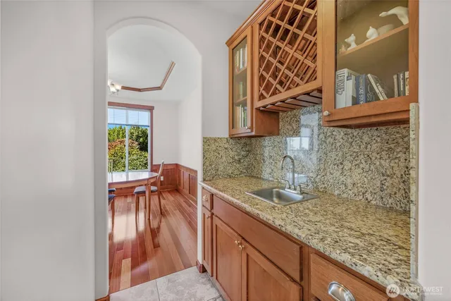 a kitchen with stainless steel appliances granite countertop a stove a sink and a microwave