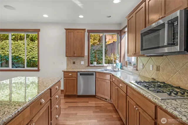 a view of a hallway with wooden floor and stairs