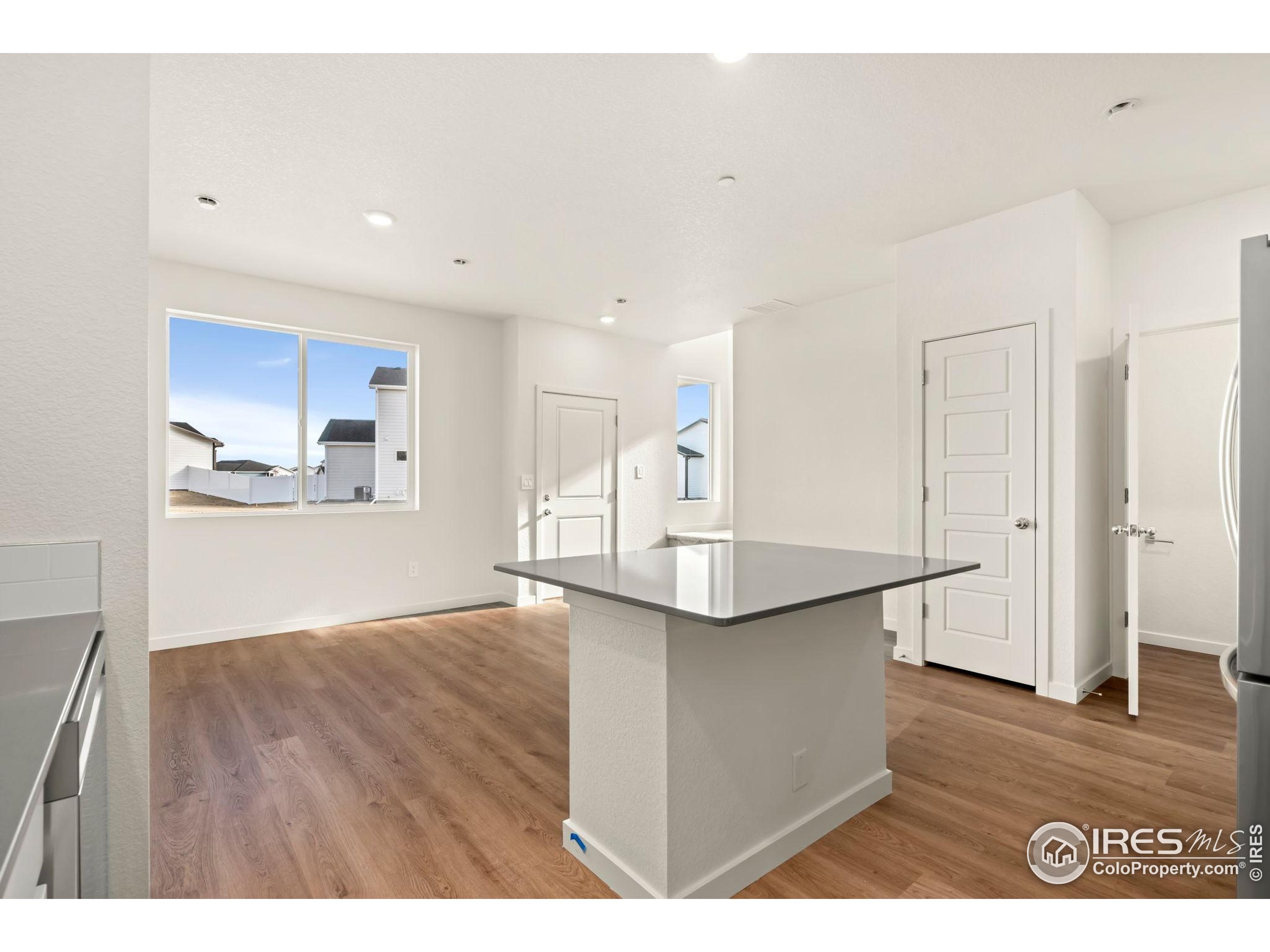 3904 Net Street Evans, CO 80620 - Photo 7 of 14 a kitchen with stainless steel appliances granite countertop a sink and a refrigerator