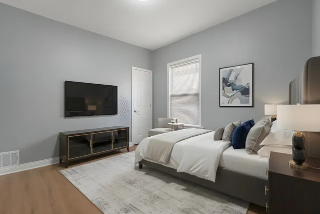 a bedroom with a bed and a flat screen tv