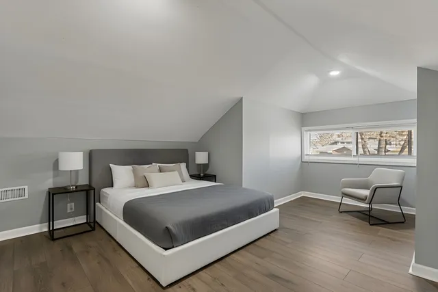 a bedroom with a bed and a chair