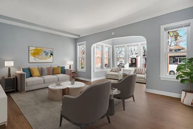 a living room with furniture and painting on the wall