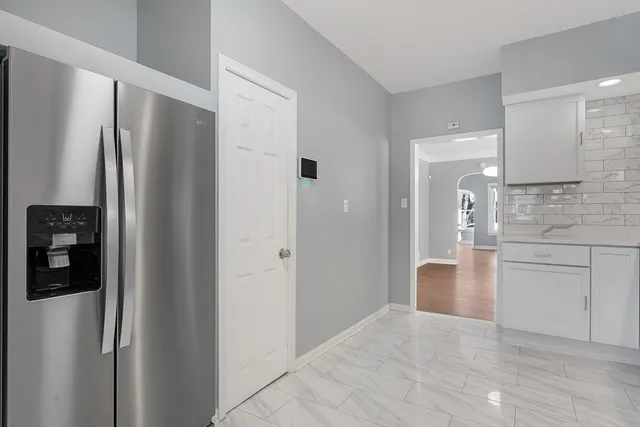 a kitchen with stainless steel appliances a refrigerator and cabinets