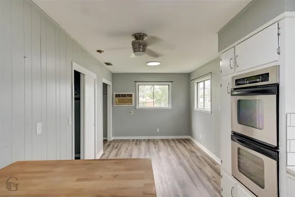 a view of a kitchen & microwave in a room