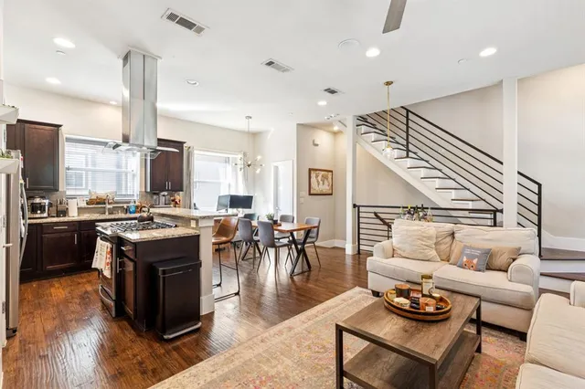 a kitchen with stainless steel appliances kitchen island granite countertop a stove and a refrigerator