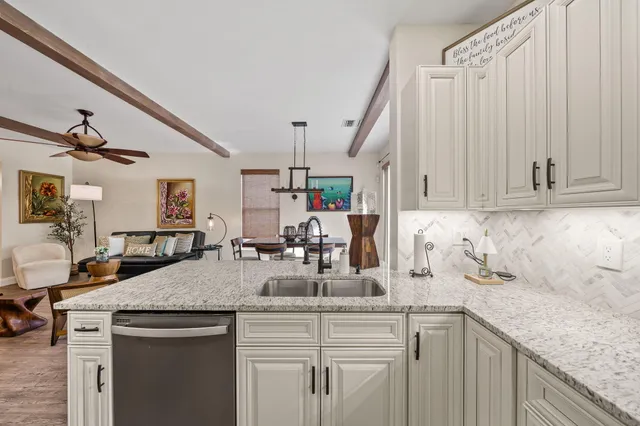 a kitchen with sink and cabinets