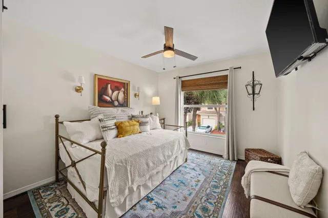 a bedroom with a bed and wooden floor