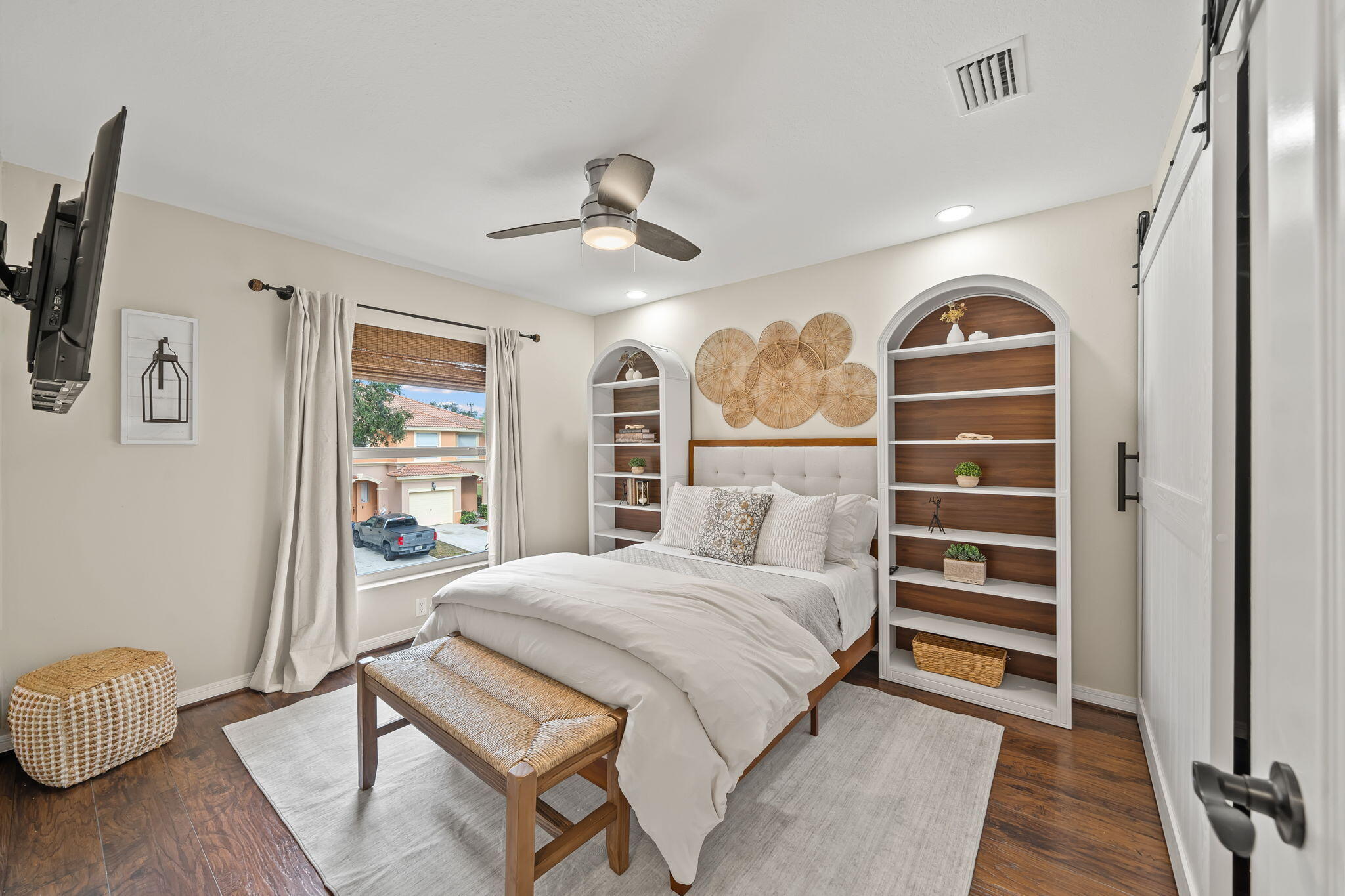 123 Wakulla Springs Way Royal Palm Beach, FL 33411 - Photo 19 of 27 a bedroom with a bed and a chandelier