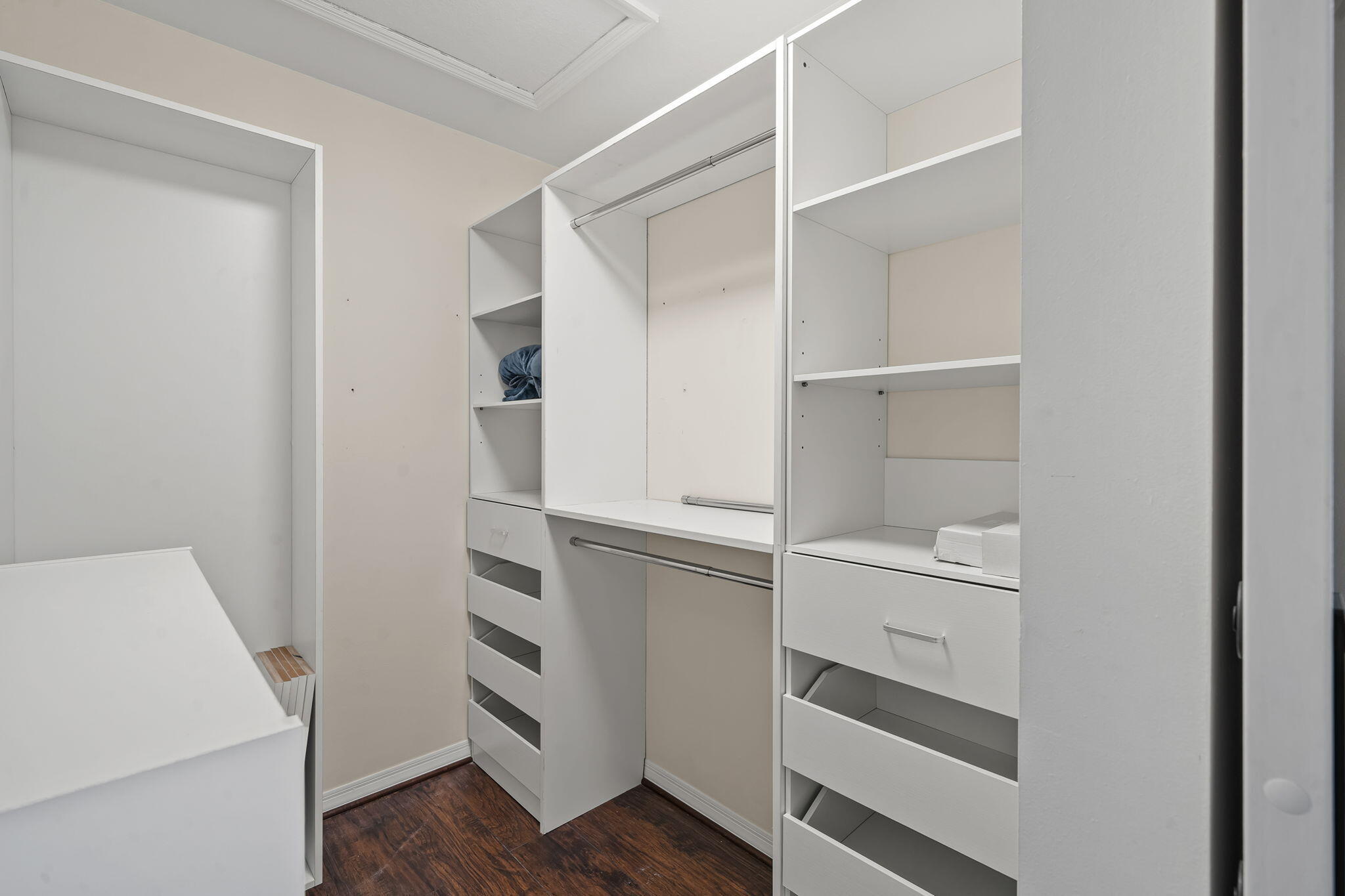 123 Wakulla Springs Way Royal Palm Beach, FL 33411 - Photo 23 of 27 a kitchen with white cabinets and wooden floor