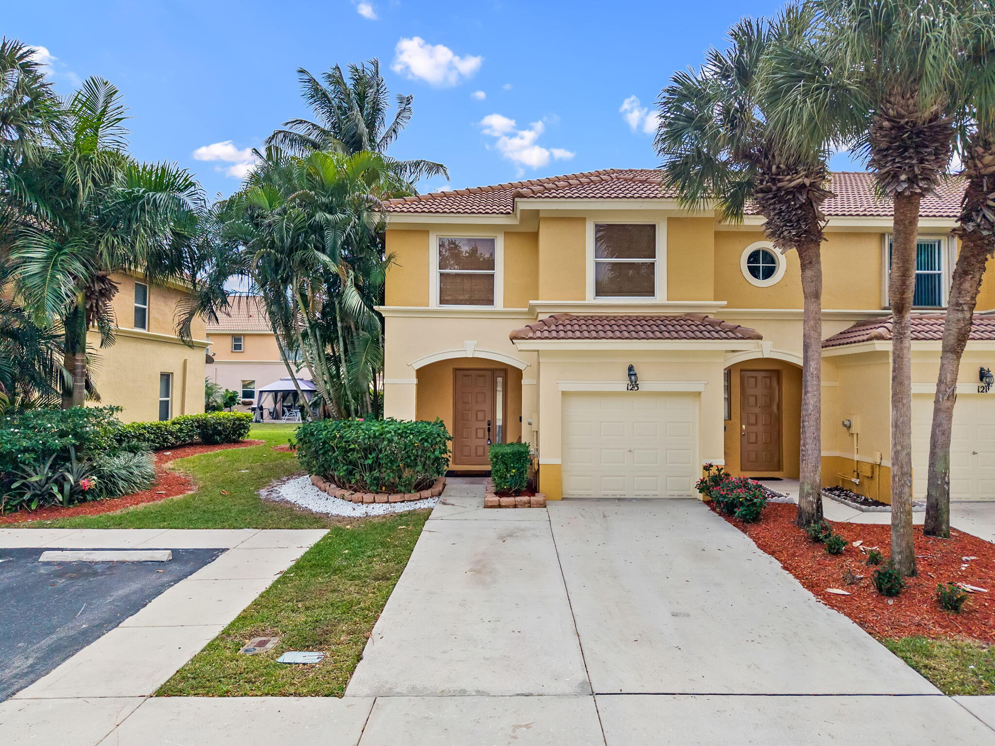 123 Wakulla Springs Way Royal Palm Beach, FL 33411 - Photo 3 of 27 a front view of a house with yard and parking