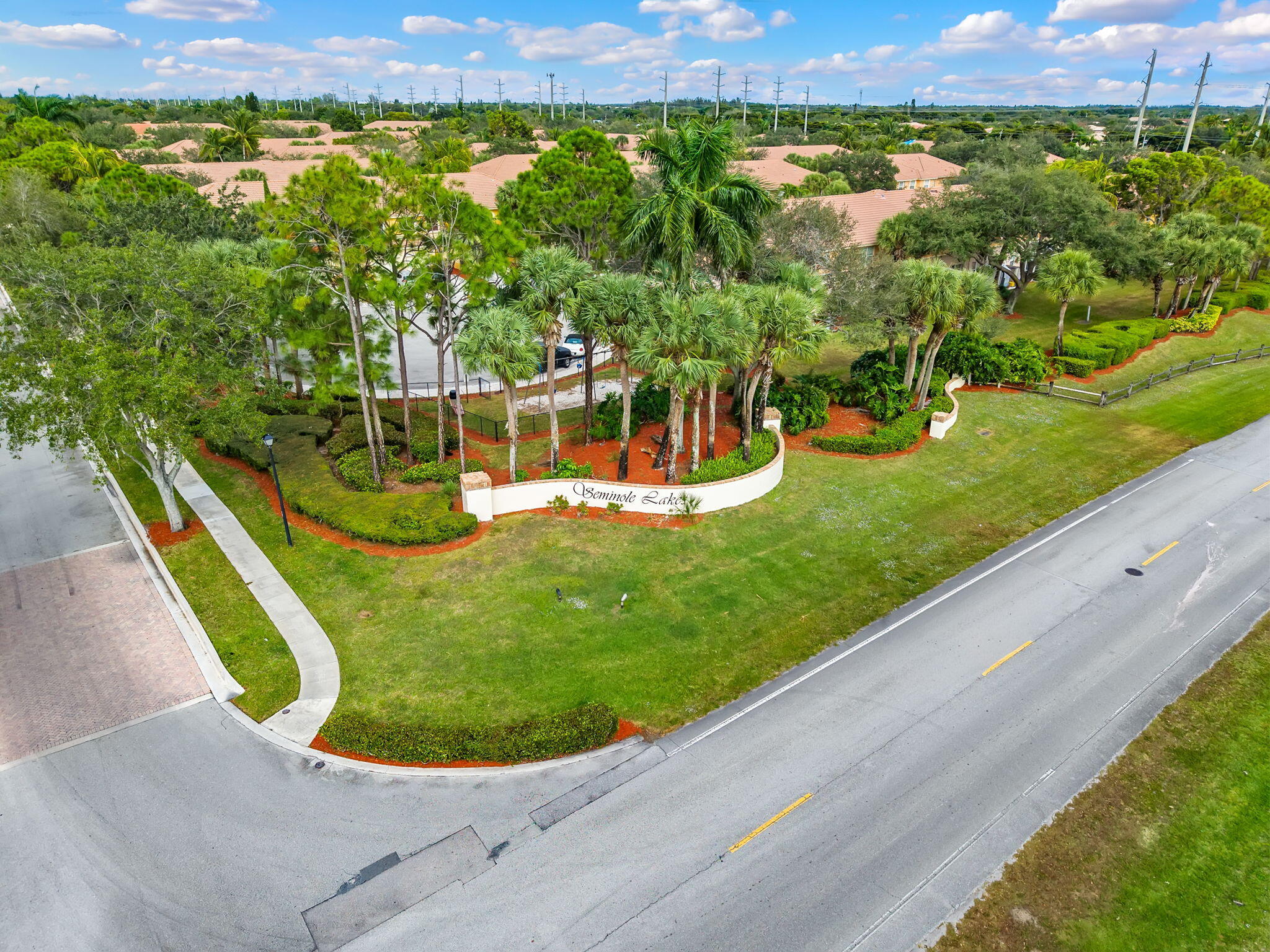 123 Wakulla Springs Way Royal Palm Beach, FL 33411 - Photo 7 of 27 an aerial view of a house with a garden and lake view