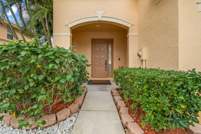 an entrance to house with yard and green space