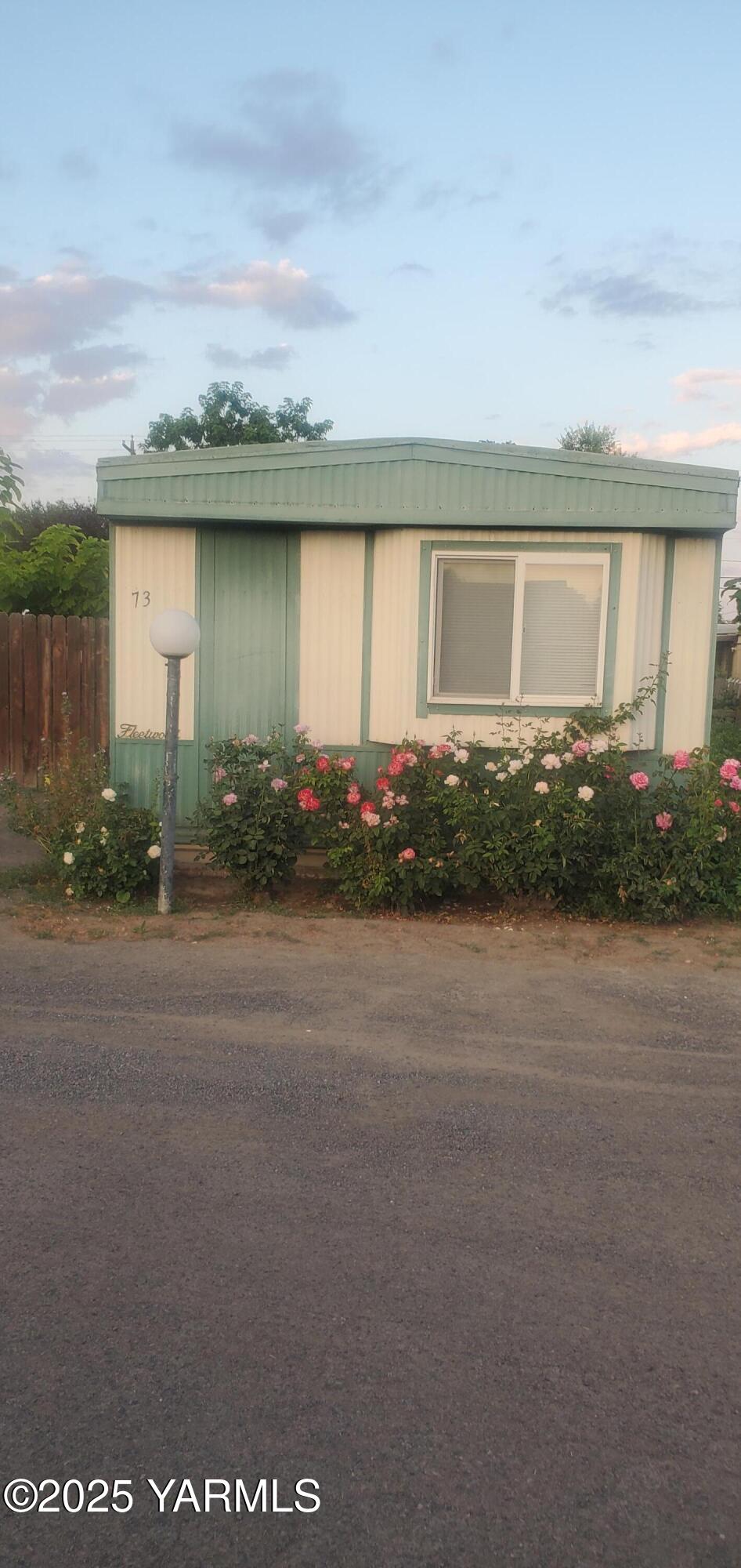 400 West 5th Street, Unit 73 Grandview, WA 98930 - Photo 3 of 6 a view of a house with a yard