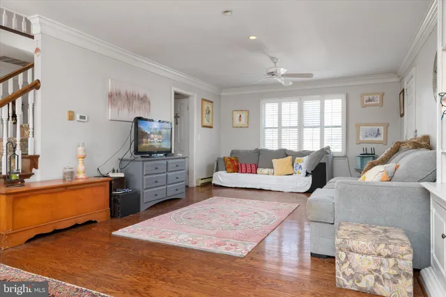 a bedroom with furniture and a flat screen tv
