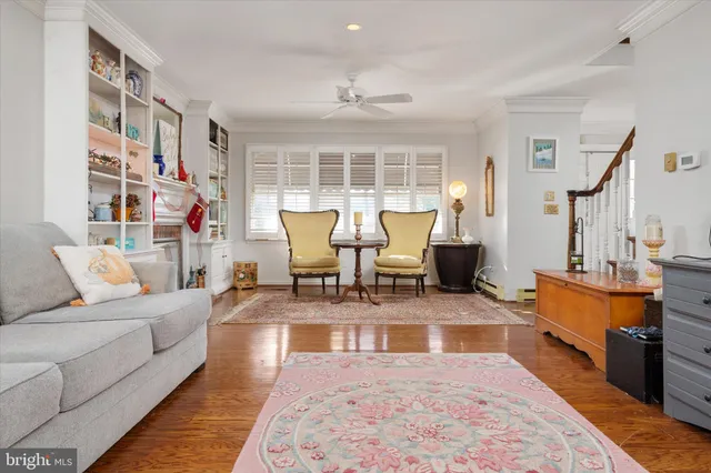 a living room with fireplace furniture and a rug