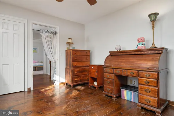 a bedroom with a bed couch and window