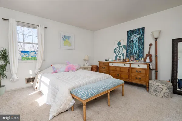 a bedroom with a large bed and couch