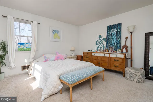 a bedroom with a large bed and couch