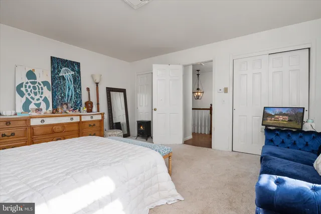 a bedroom with a bed and a dresser