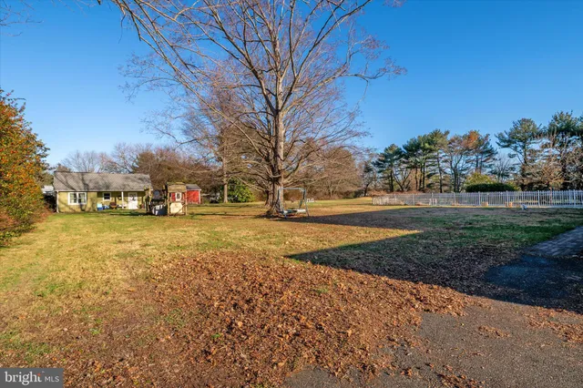 a yard with lots of green space and trees