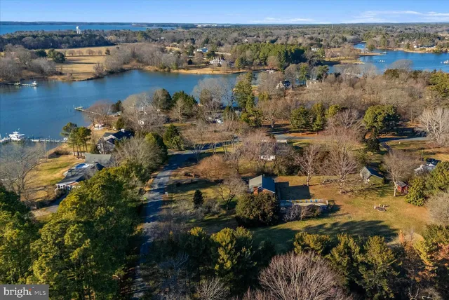 an aerial view of ocean with residential house with outdoor space