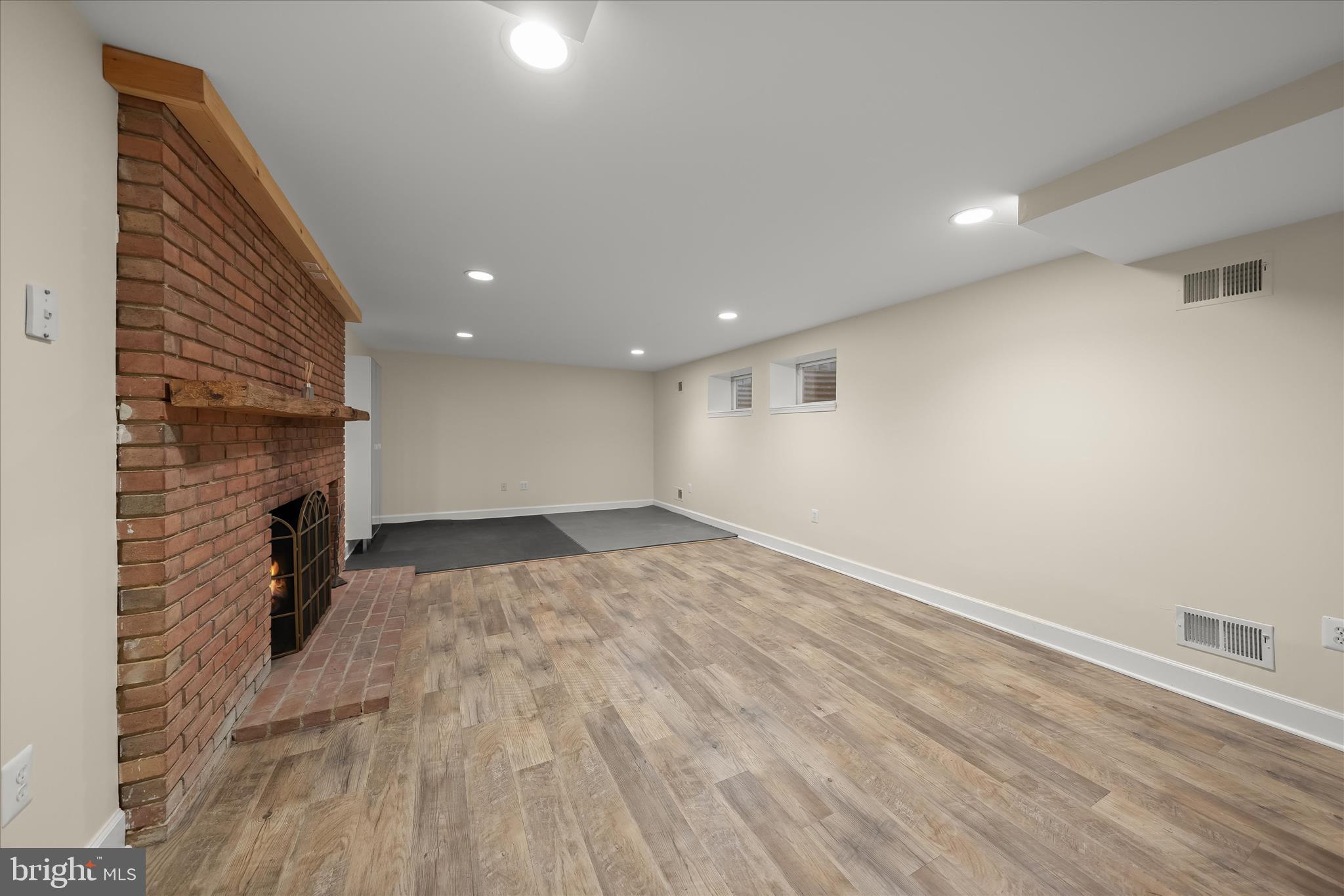 5104 Scarsdale Road Bethesda, MD 20816 - Photo 51 of 68 a view of an empty room with wooden floor and a kitchen