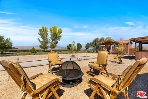 a view of a chairs and table in patio
