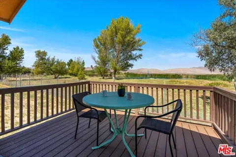 a view of a chairs and table on the deck