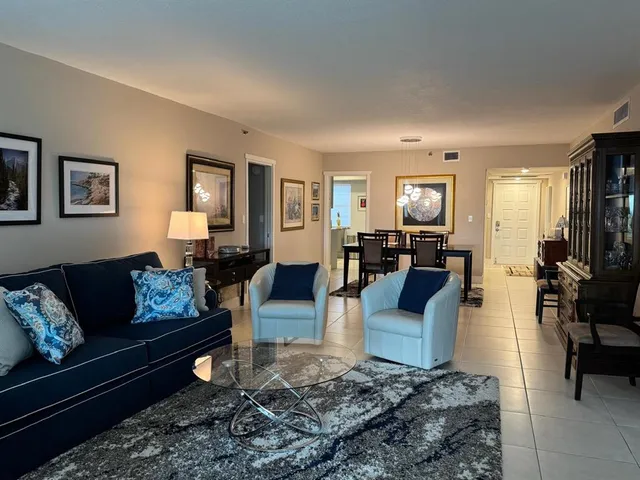 a living room with furniture wooden floor and a window