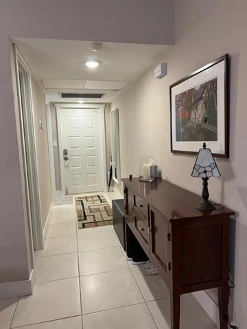 a bathroom with a granite countertop toilet sink and mirror