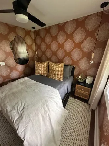 a bedroom with a bed and a mirror
