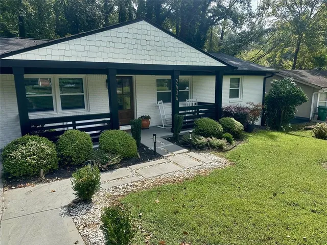 a front view of a house with garden and porch