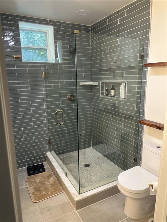2434 Rockcliff Road Southeast Atlanta, GA 30316 - Photo 22 of 26 a bathroom with a shower and a toilet