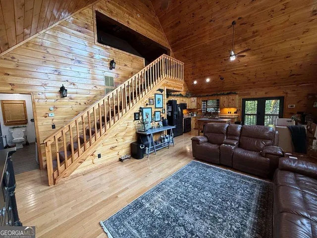 a living room with lots of furniture and stairs