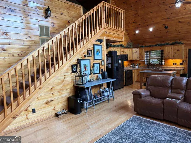 a living room with furniture and stairs
