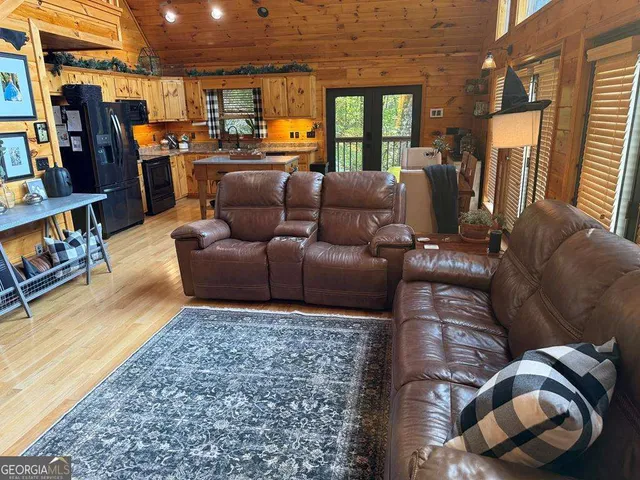a living room with furniture fireplace and a window