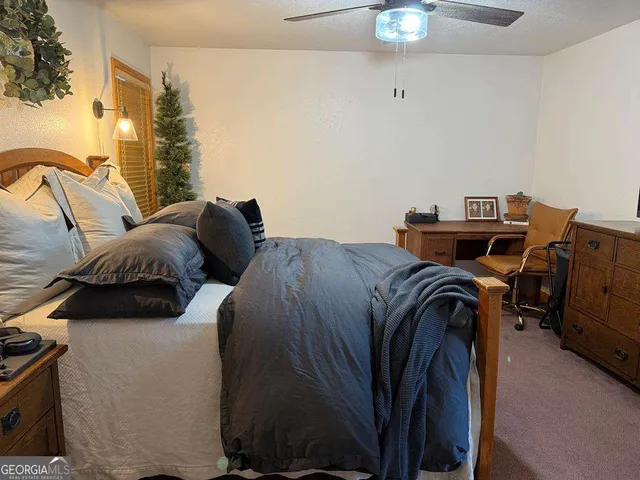 a bed sitting in a bedroom next to a window