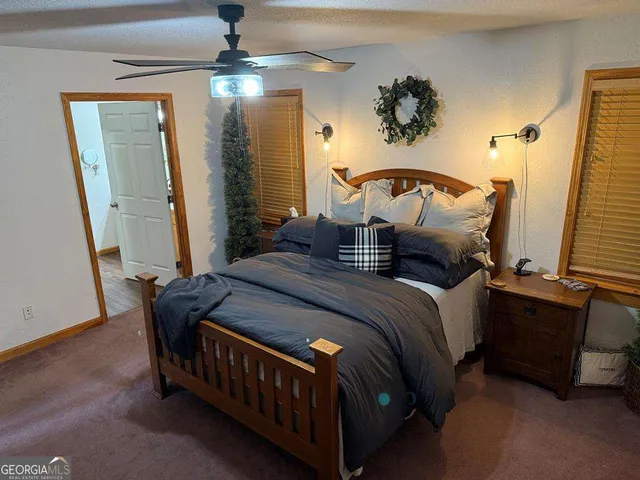 a bedroom with bed and a chandelier