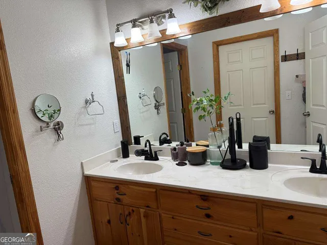a bathroom with a double vanity sink and a mirror