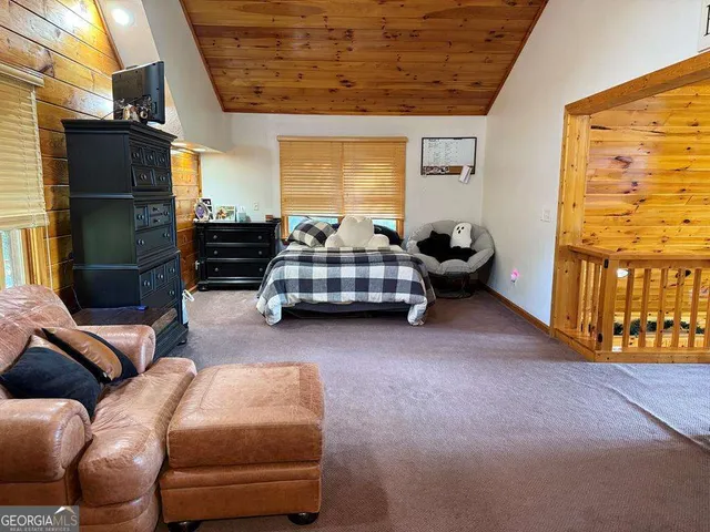 a bedroom with furniture and a flat screen tv