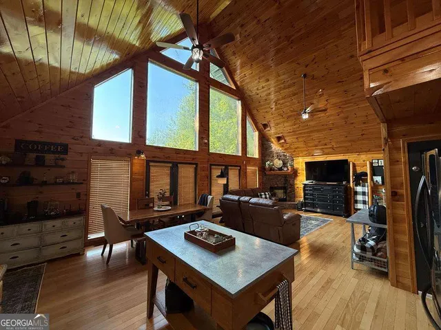 a living room with furniture a flat screen tv and a table