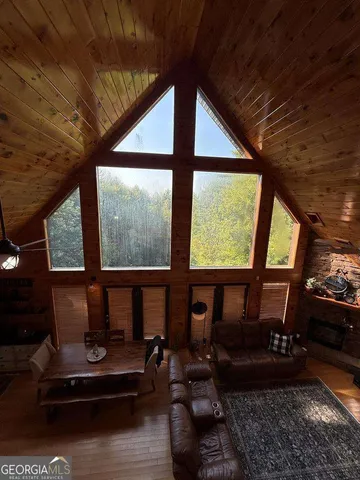 a living room with furniture and floor to ceiling window