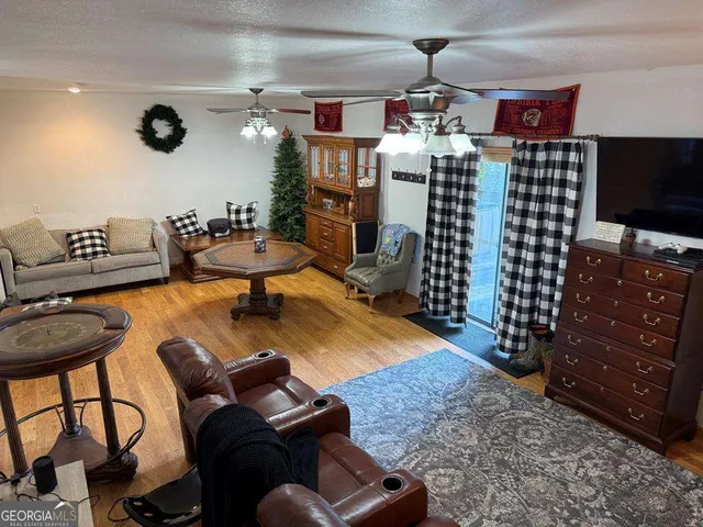 a living room with furniture and wooden floor