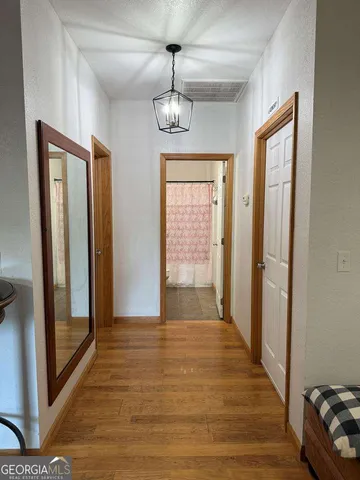 a bedroom with a bed and chandelier