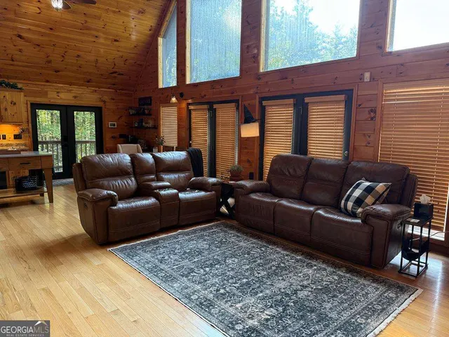 a living room with furniture windows and wooden floor