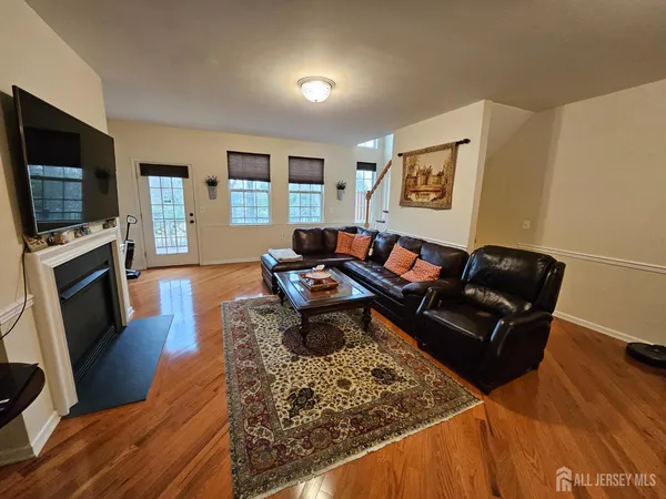 a living room with furniture and a wooden floor