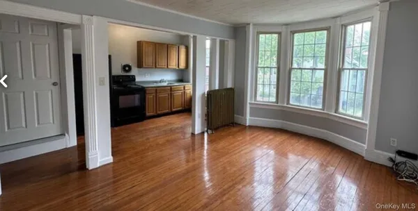 a view of a kitchen with wooden floor and electronic appliances