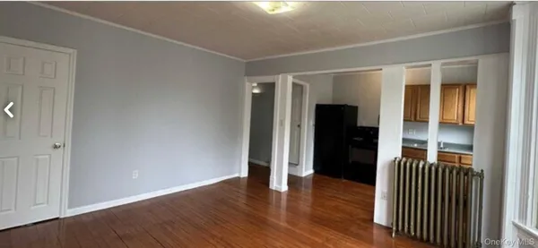 an empty room with wooden floor and closet
