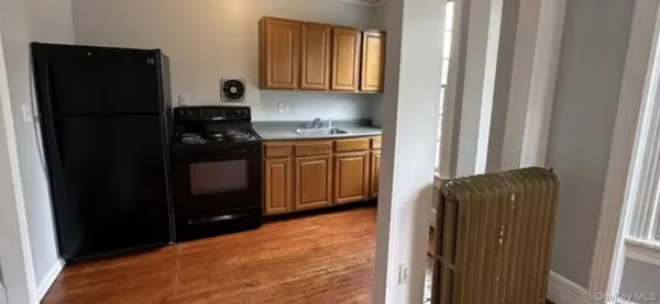 a kitchen with stainless steel appliances granite countertop a refrigerator and a stove